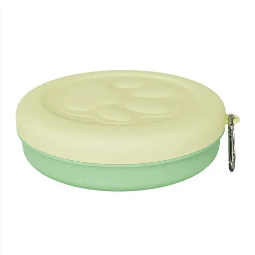 Portable dog feeding bowl with a removable silicone base in pink and green colour options.