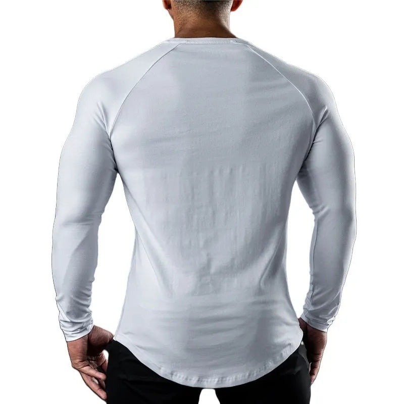 Man wearing a grey long sleeve cotton sports t-shirt with a round neck.