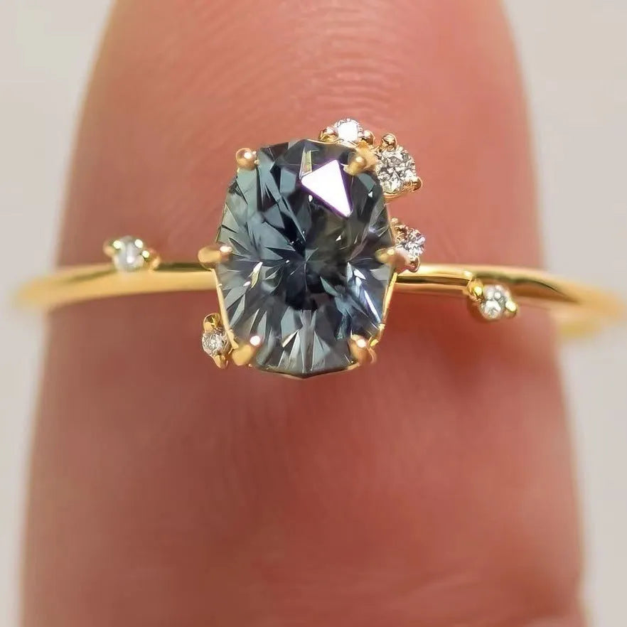 Gold plated women's flower-shaped ring with a green zircon stone, shown in a pair.