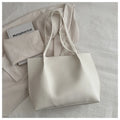 PU leather messenger bag in bucket shape with stitching detail, black colour, double shoulder straps, open pocket outer
