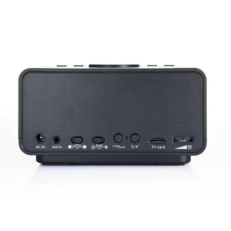 Black and white wireless alarm clock Bluetooth speaker with control buttons on top.