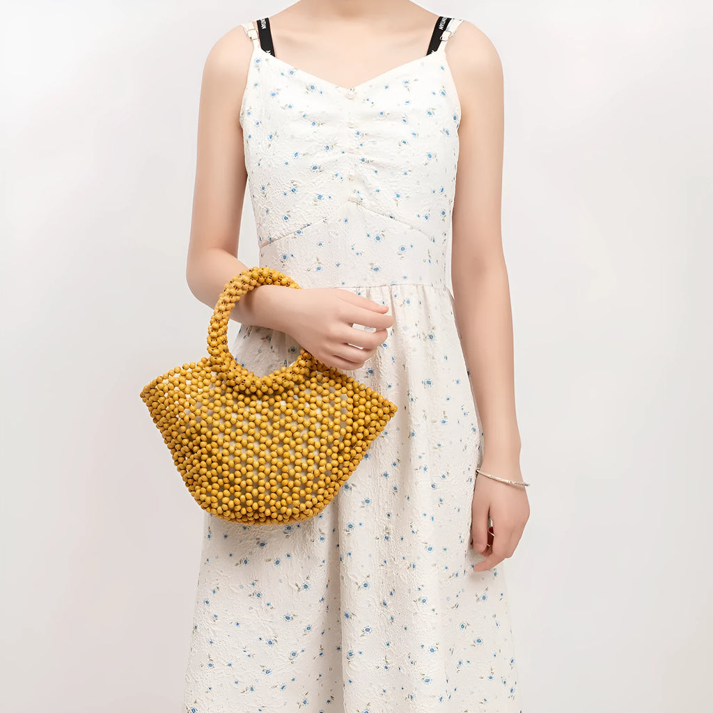 Hand-woven maple wooden bead beach bag in dumpling shape with hollow weave design