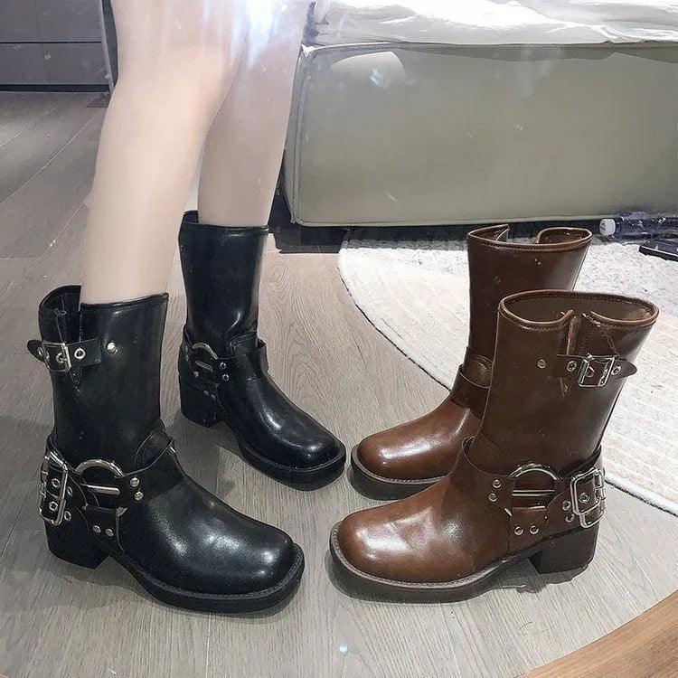 Women's black platform ankle boots with belt buckle detail and mid-calf length