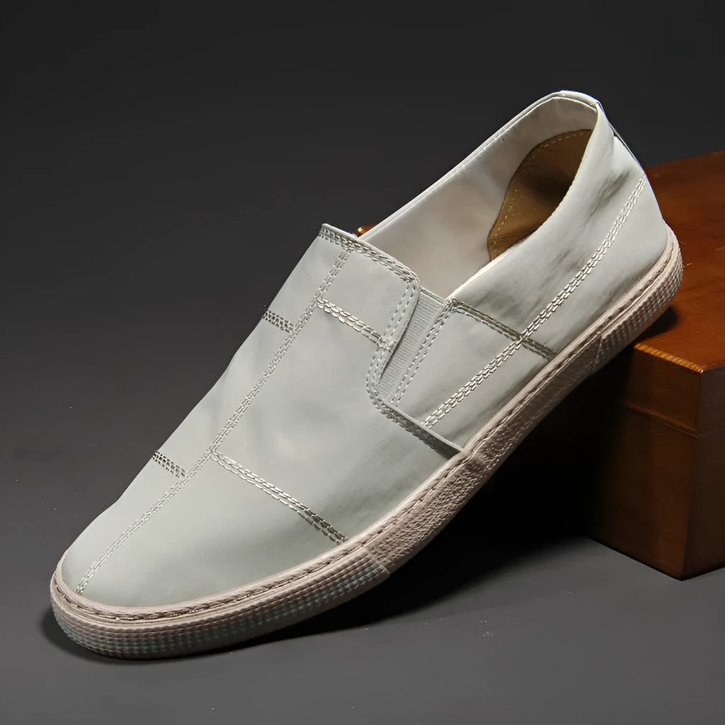 Men's low-top slip-on canvas shoes in multiple colours with round toe and flat rubber sole.