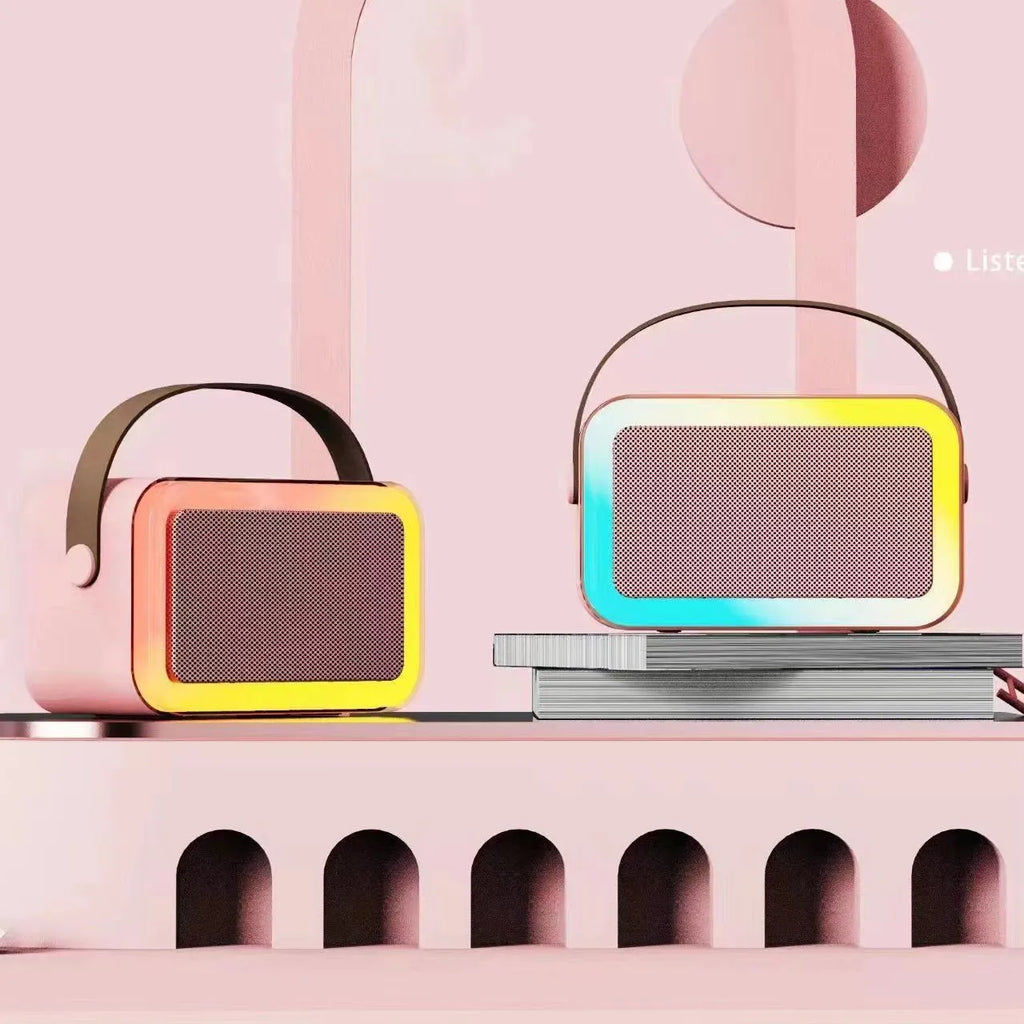White portable Bluetooth karaoke speaker with coloured lights and a handheld microphone.
