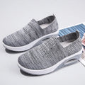 Women's beige casual running shoes with mesh upper and air cushion sole on a white background.