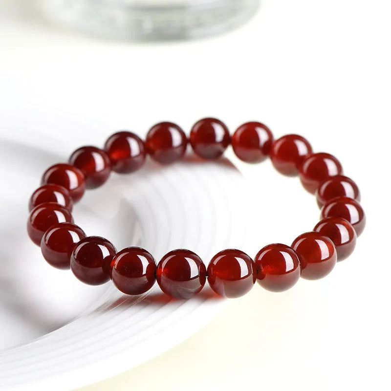 Natural orange red garnet ball bracelet with Ruyi design elements on crystal beads