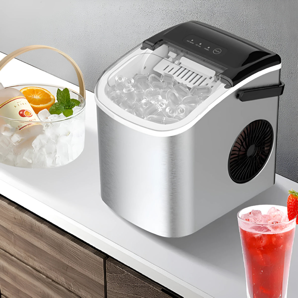 Silver countertop home ice machine with 1.2L capacity and push-button control on a kitchen counter