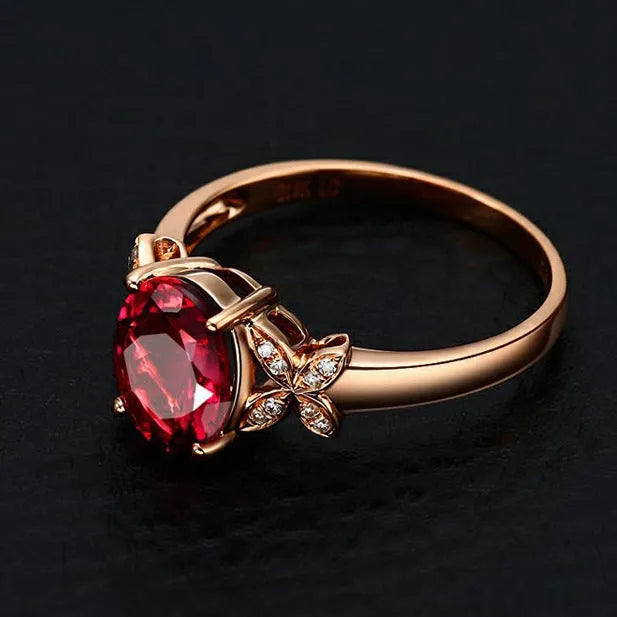 Women's butterfly ring with heart-shaped design in copper and rose gold plating, showing blue and red colour options