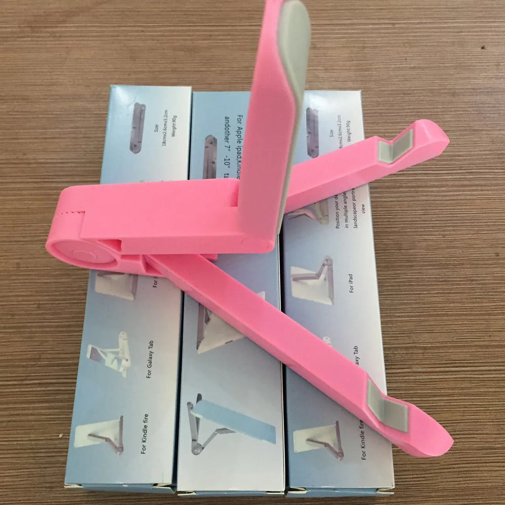 Black foldable tablet holder showing folded size next to tablet for scale