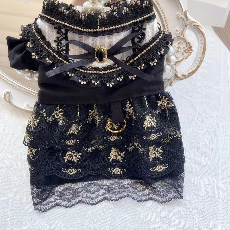 Golden gothic style skirt costume for a small dog or cat on a hanger.