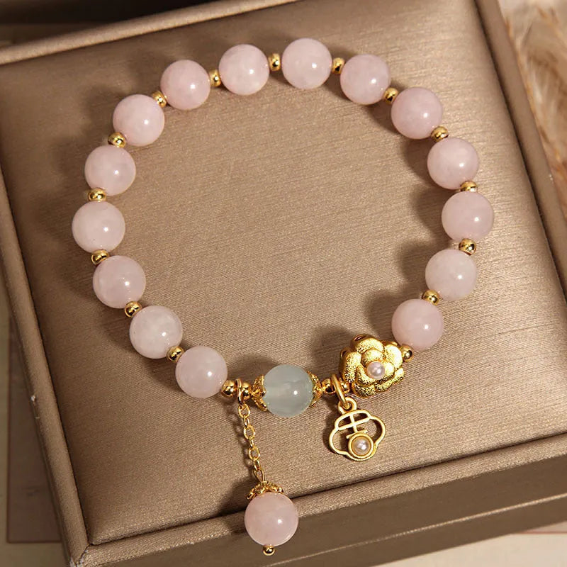 Women's pink crystal flower bracelet with clear crystal stones forming floral design pattern.