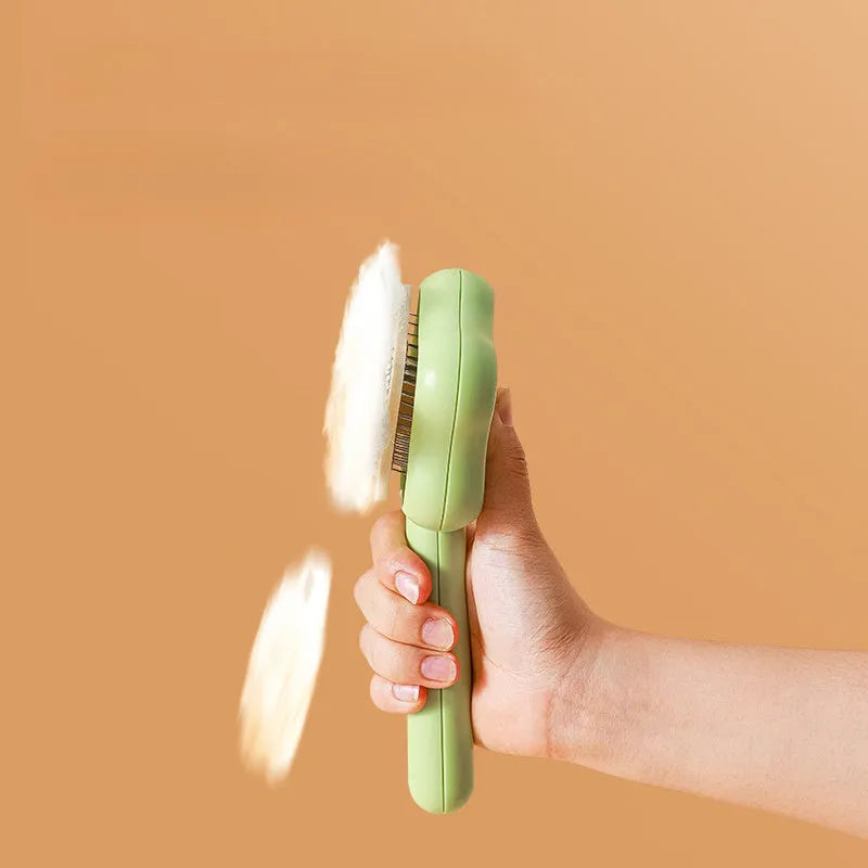 Self-cleaning stainless steel pet comb with green handle, showing the 20cm length and needle teeth
