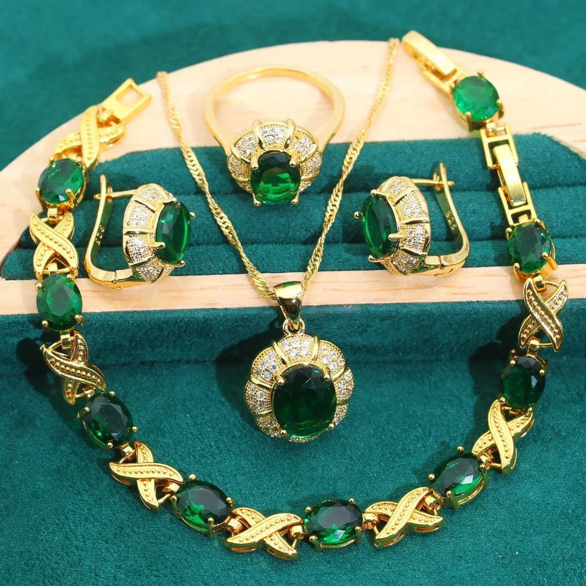 18k gold plated jewellery set showing ring, earrings, bracelet, and necklace with coloured cubic zirconia stones.