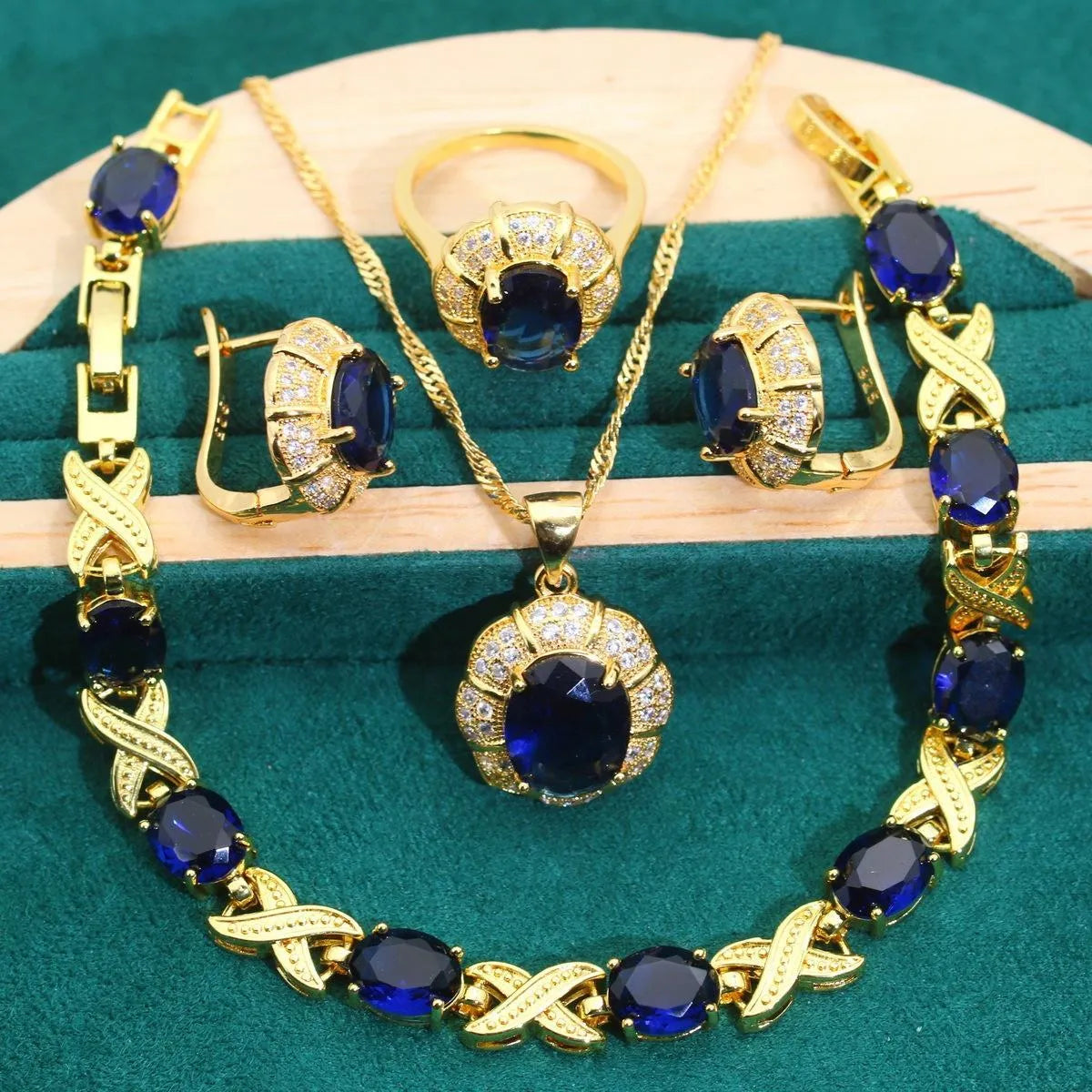 18k gold plated jewellery set showing ring, earrings, bracelet, and necklace with coloured cubic zirconia stones.