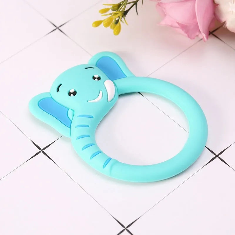 Three silicone baby molar teethers in brown, blue, and yellow on a light background