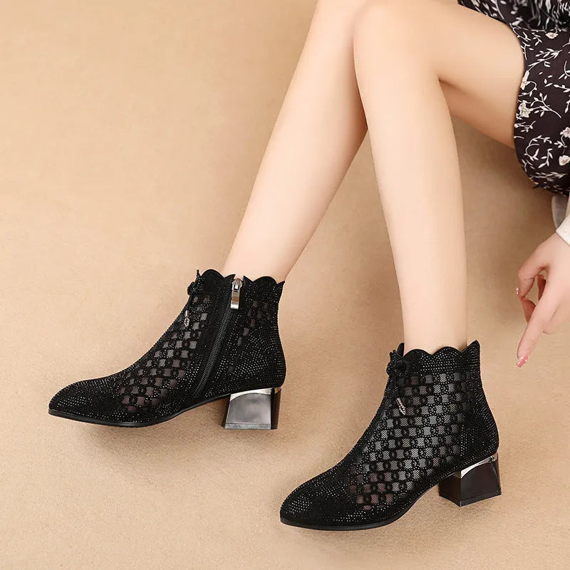 Women's black cutout mesh ankle boots with mid heel and rhinestone trim, side zipper closure