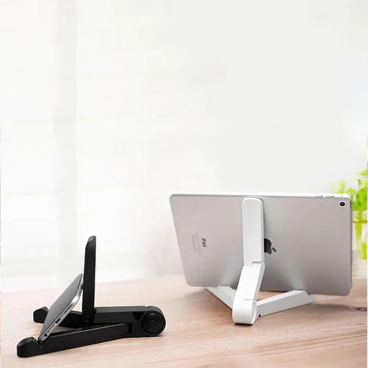 Black foldable tablet holder showing folded size next to tablet for scale