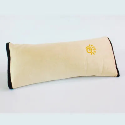 Children car pillow in grey micro-suede fabric attached to a car seat belt shoulder strap
