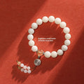 White jade bodhi couple bracelet with ruyi element and 10mm round beads.