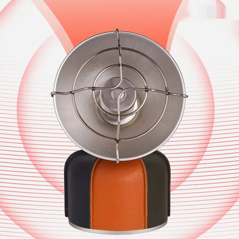 Black and orange portable outdoor gas heating stove with automatic ignition on a camping table.