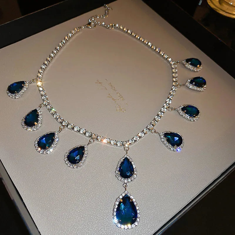 Silver needle water drop earrings and necklace set with blue zircon pendant on display