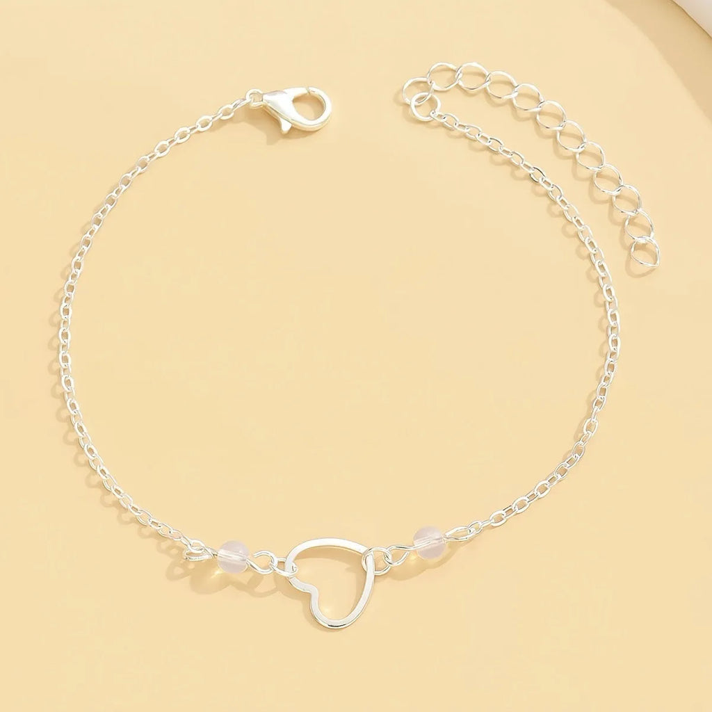 Adjustable women's anklet with heart-shaped pendant in gold or silver finish