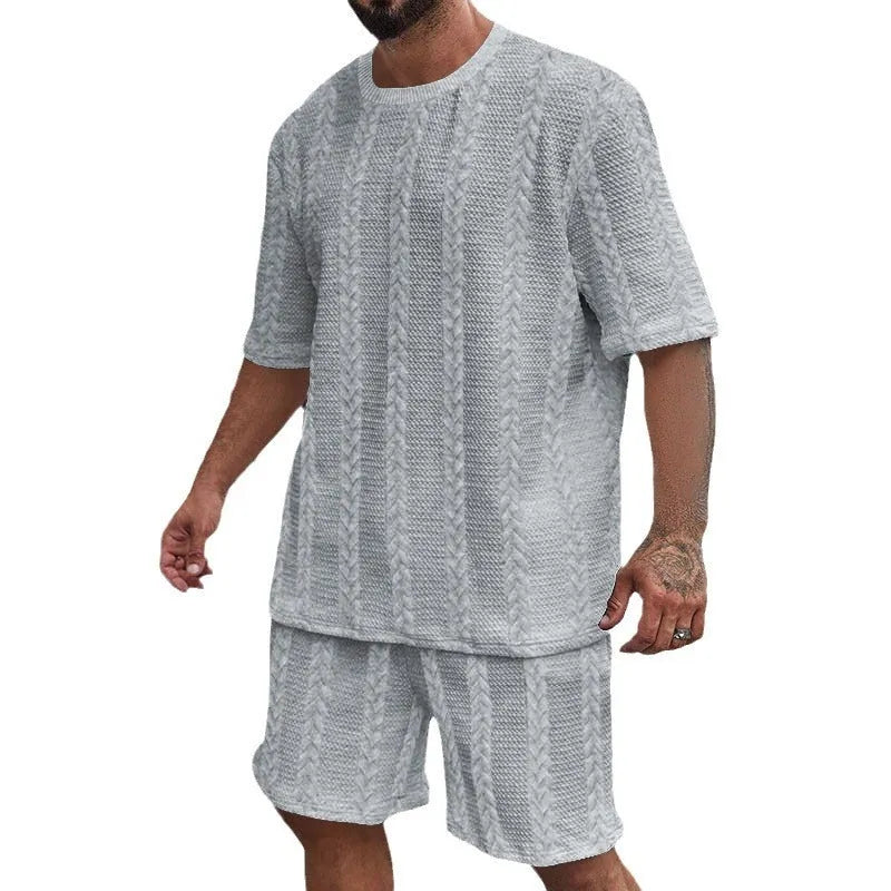 Knitted jacquard short sleeve pullover and matching shorts set in a solid colour on a hanger.