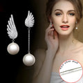 Silver angel wing earrings with diamond treatment and gold-plated gemstone accents