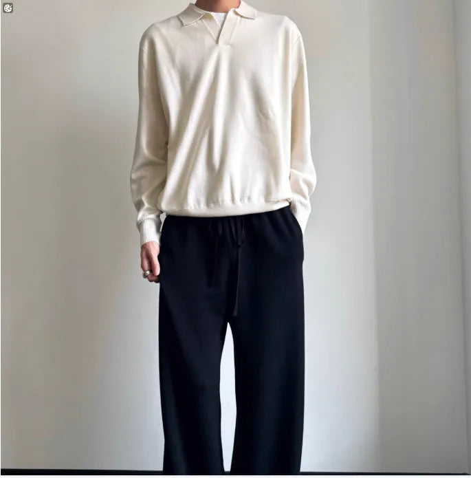 Pure wool polo sweater with a lapel collar in navy blue, shown in a loose fit on a model.