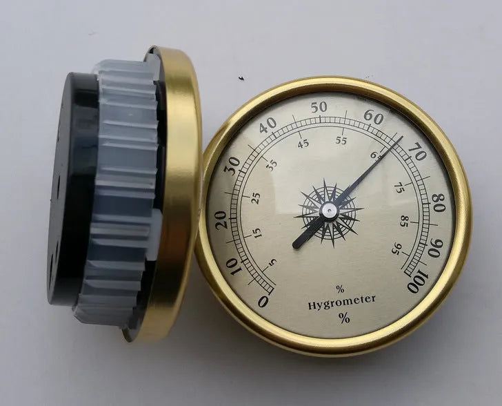 Analogue thermometer and hygrometer with aluminium ring and dial showing temperature and humidity scales.