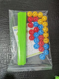 Children's fort building kit showing plastic rods, connector balls, and a constructed play tent frame.