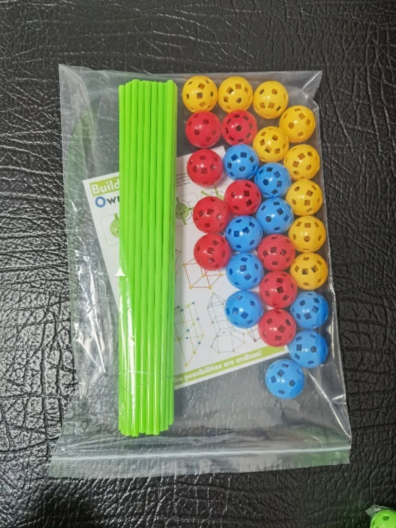 Children's fort building kit showing plastic rods, connector balls, and a constructed play tent frame.