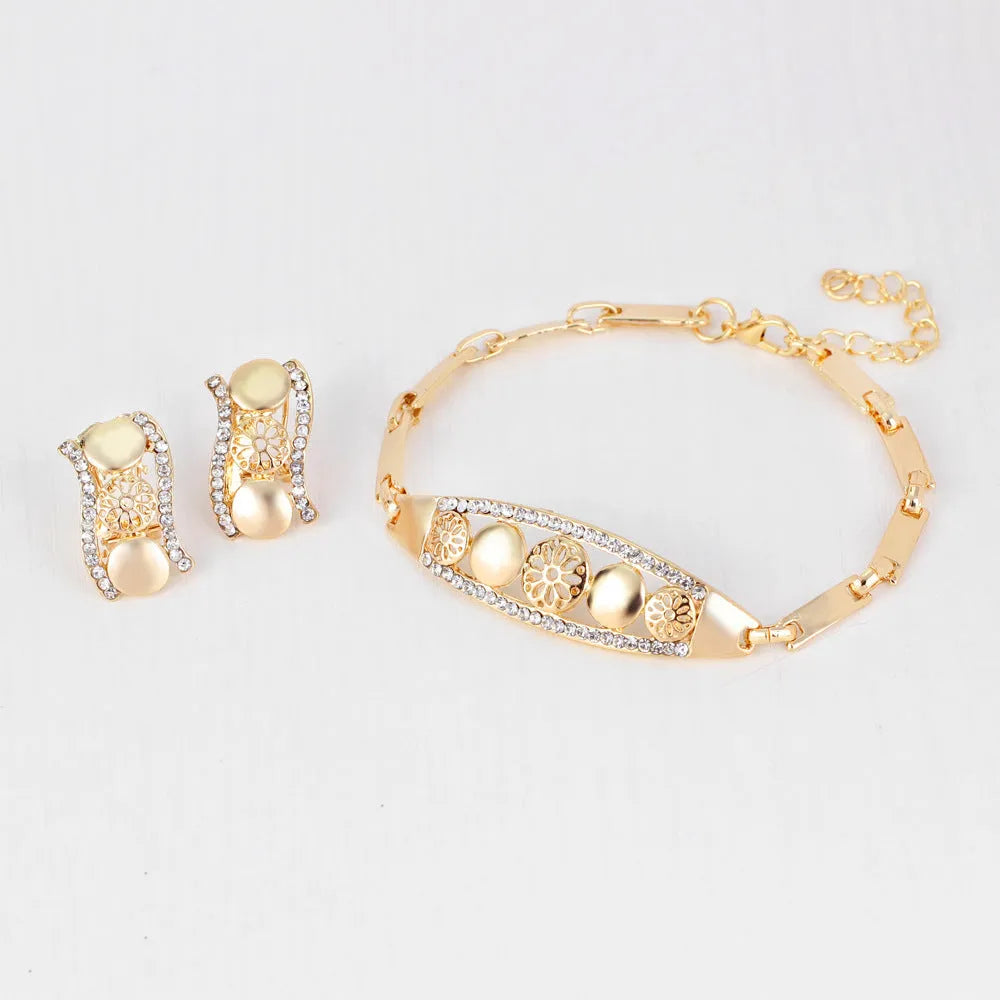 Four-piece gold tone crystal bridal jewellery set with necklace earrings bracelet and ring on display