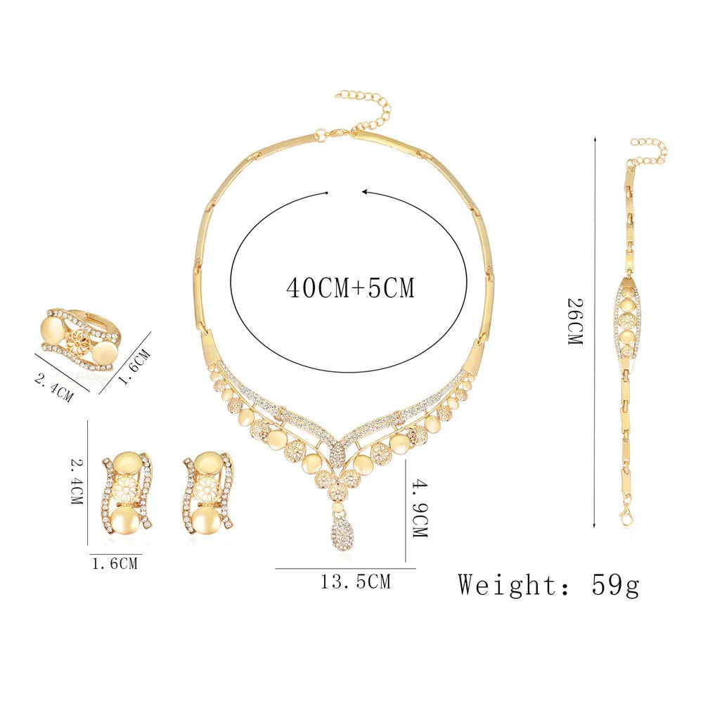 Four-piece gold tone crystal bridal jewellery set with necklace earrings bracelet and ring on display