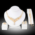 Four-piece gold tone crystal bridal jewellery set with necklace earrings bracelet and ring on display