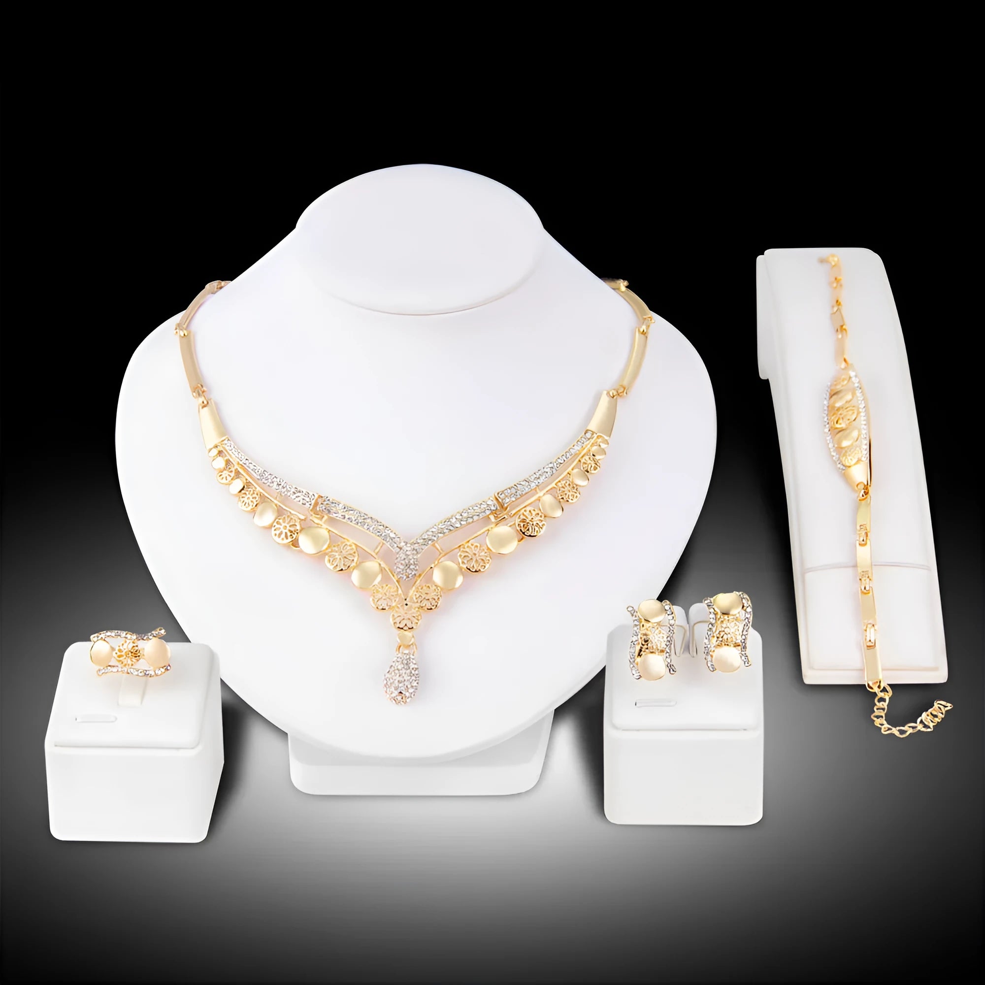 Four-piece gold tone crystal bridal jewellery set with necklace earrings bracelet and ring on display