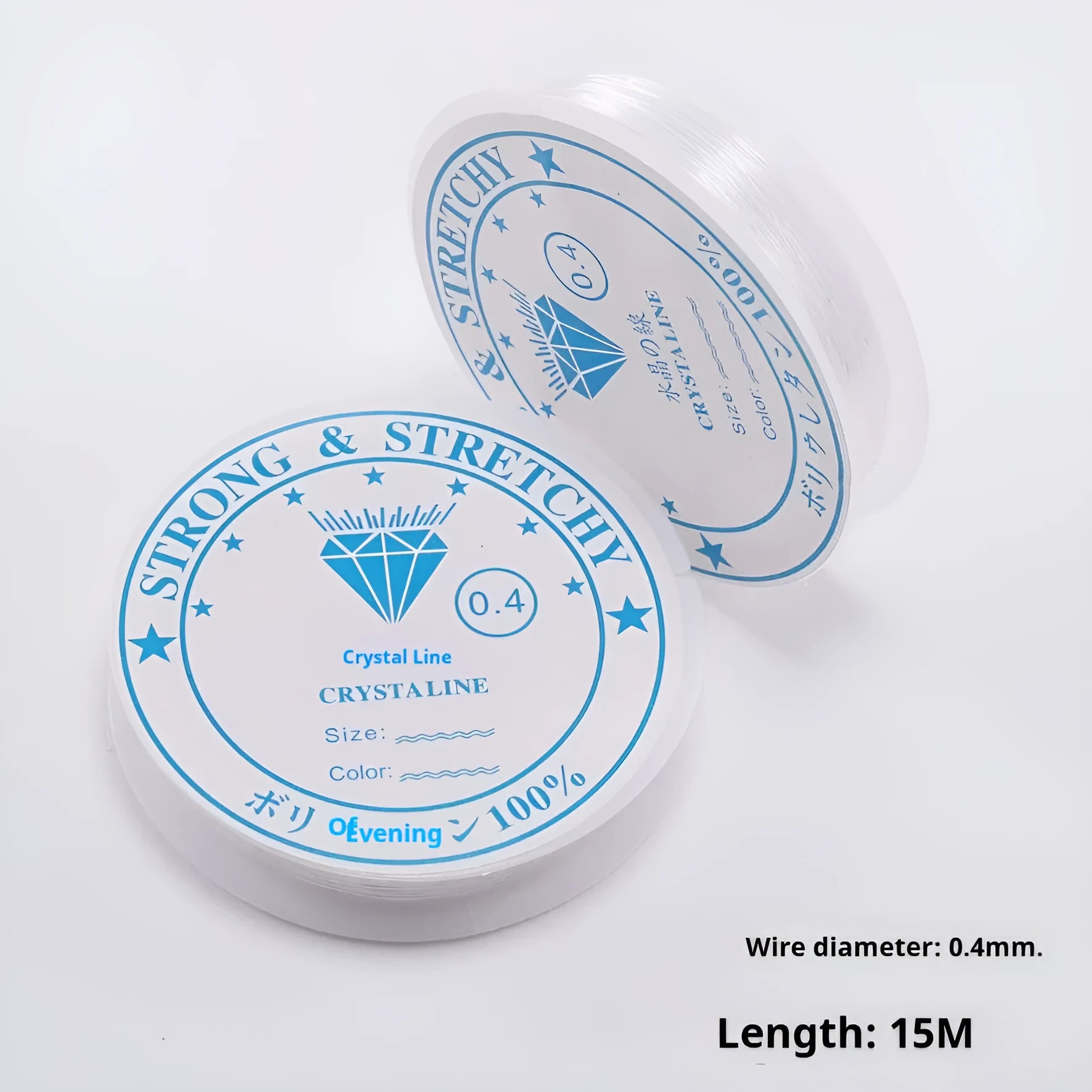 Spool of transparent white elastic cord for jewellery making on a craft table.