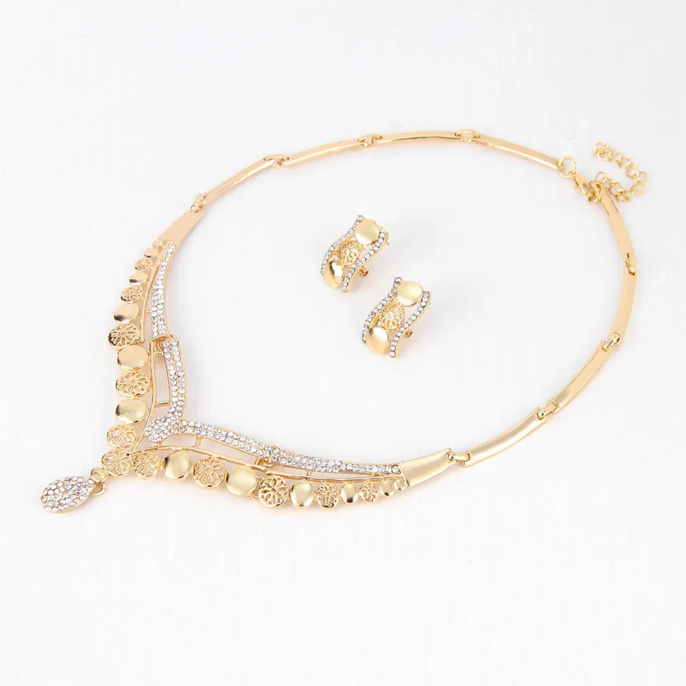Four-piece gold tone crystal bridal jewellery set with necklace earrings bracelet and ring on display