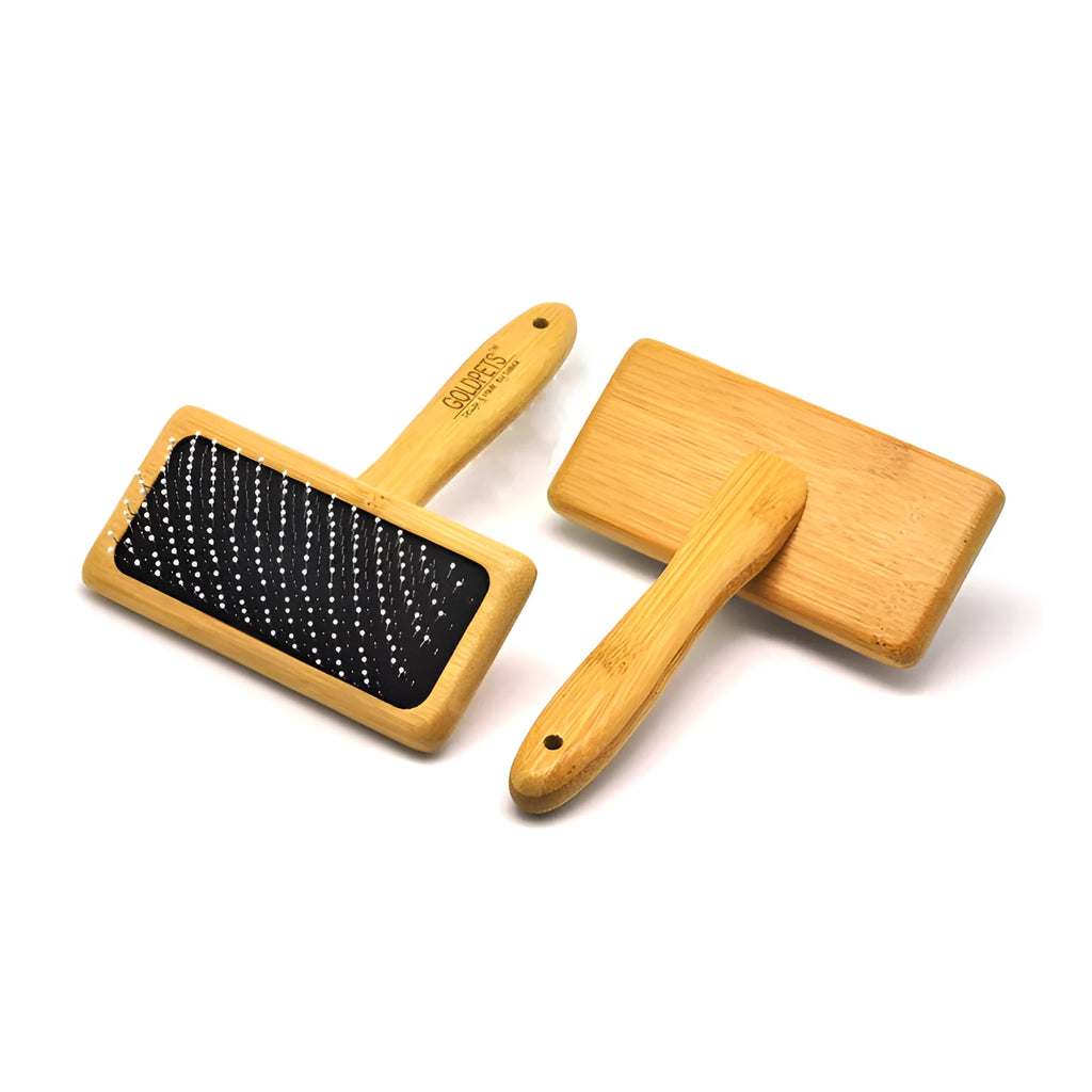 Pet grooming bamboo wood air cushion needle comb in original bamboo colour with steel pins, shown on a table