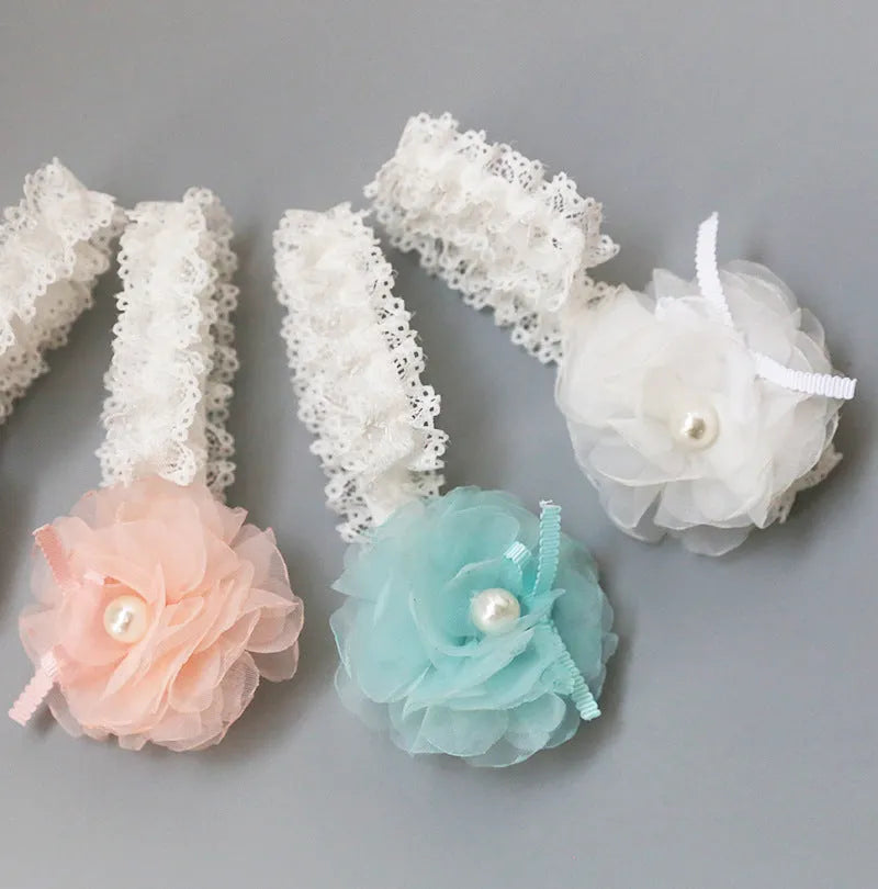 Korean children's fabric flower hairpins in pink and white on display