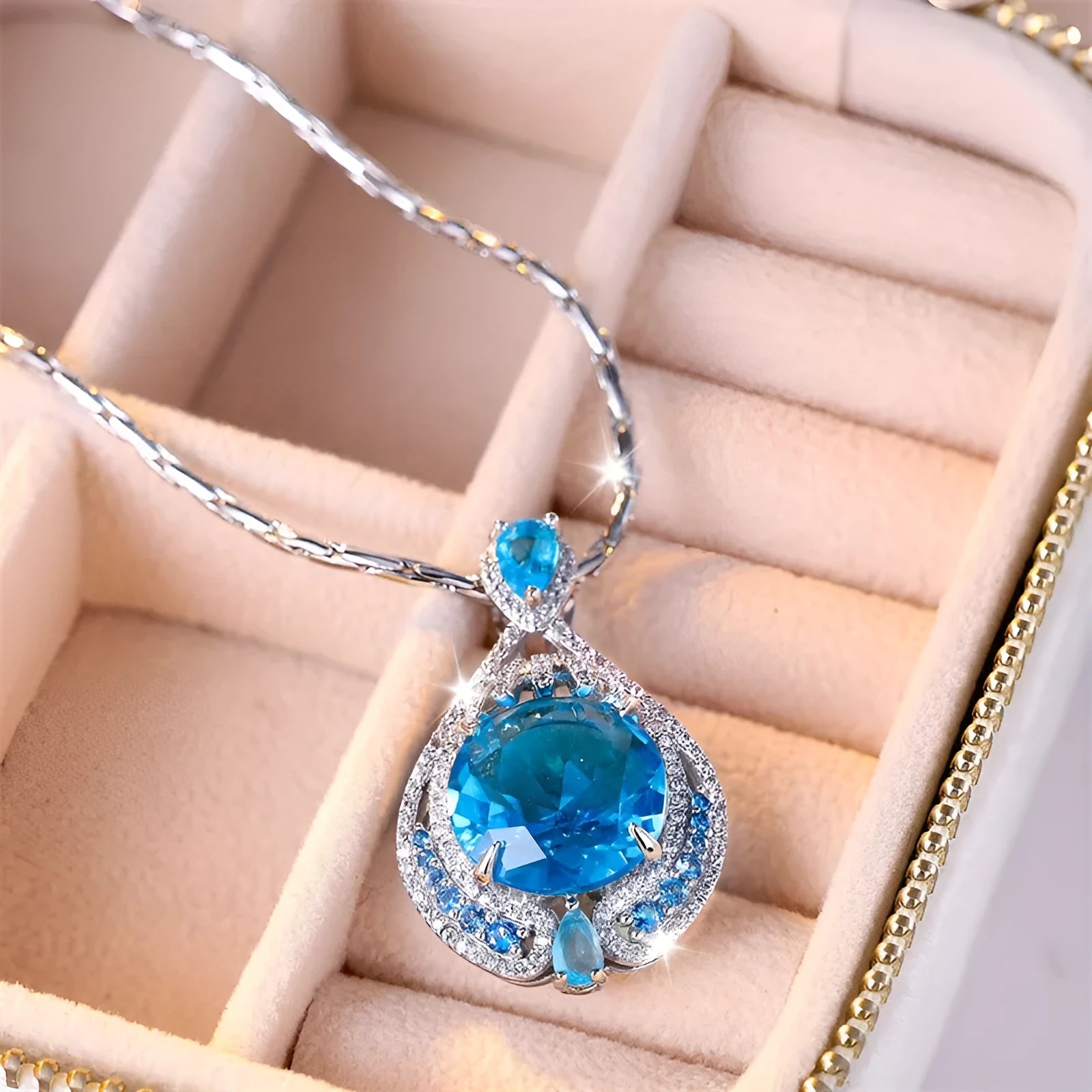 Blue geometric necklace with fireworks-cut crystal pendant on water wave chain