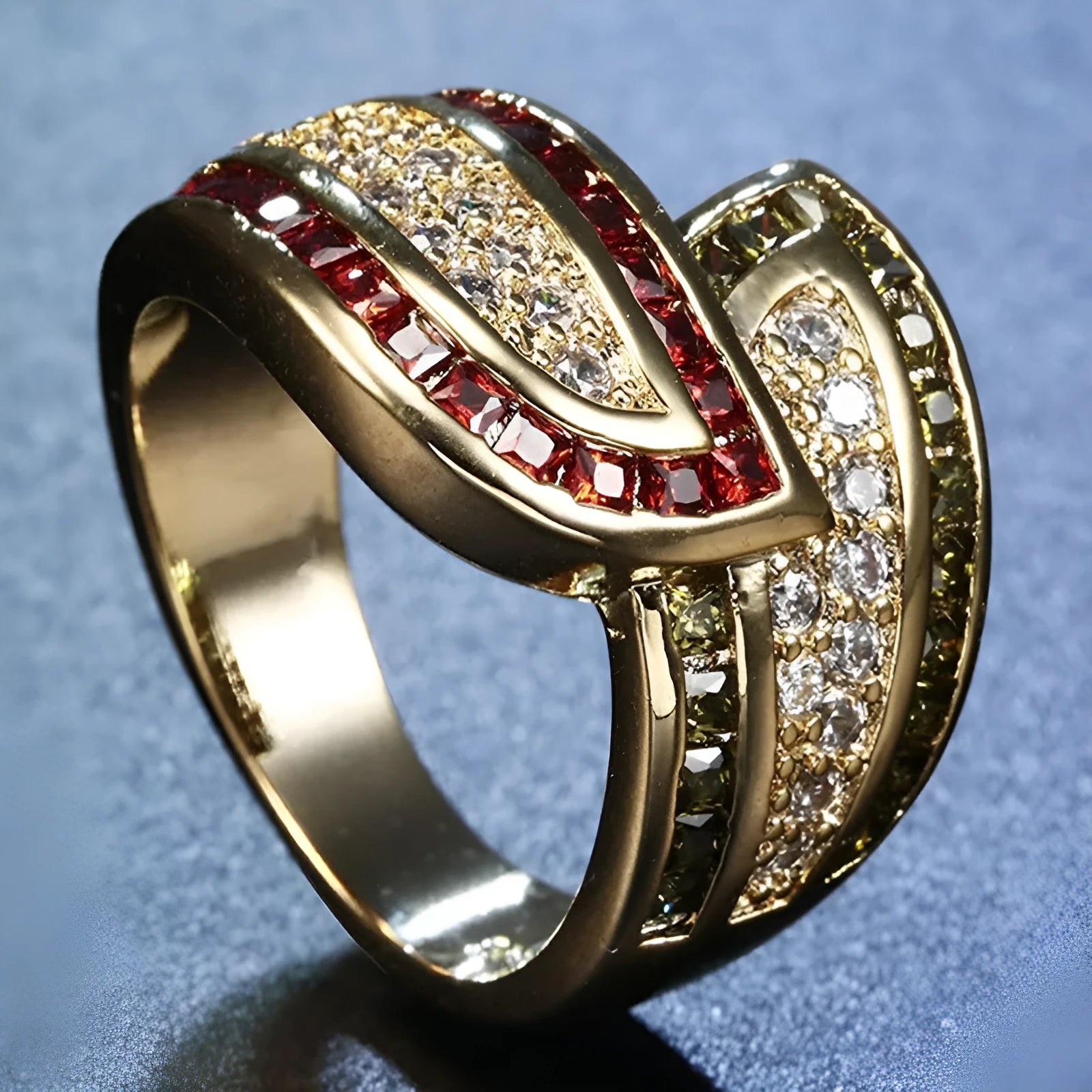 Gold women's ring with green peridot stone on finger, showing metallic finish and stone detail