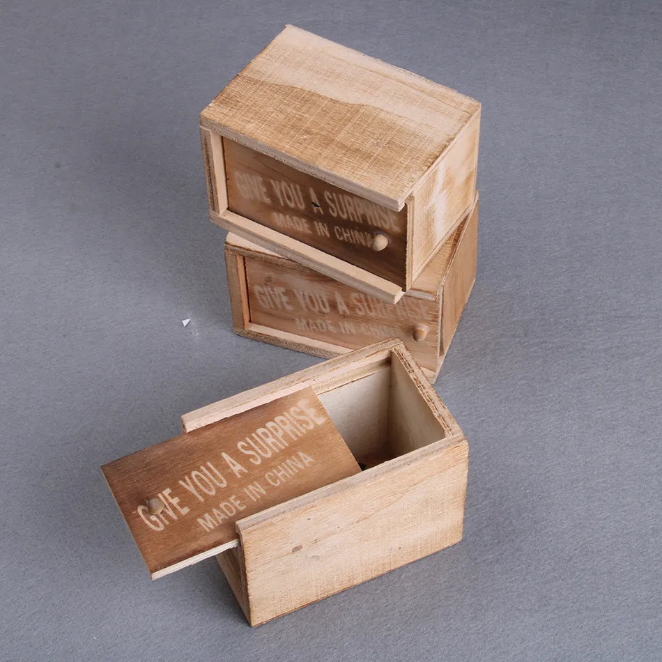 A closed wooden prank scare box measuring 9.1 cm, with a random lifelike animal inside ready to jump out.