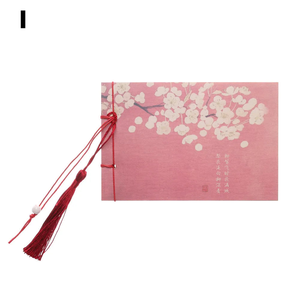A5 kraft paper notebook with a hand-stitched binding and a hanging tassel bookmark in a natural design.