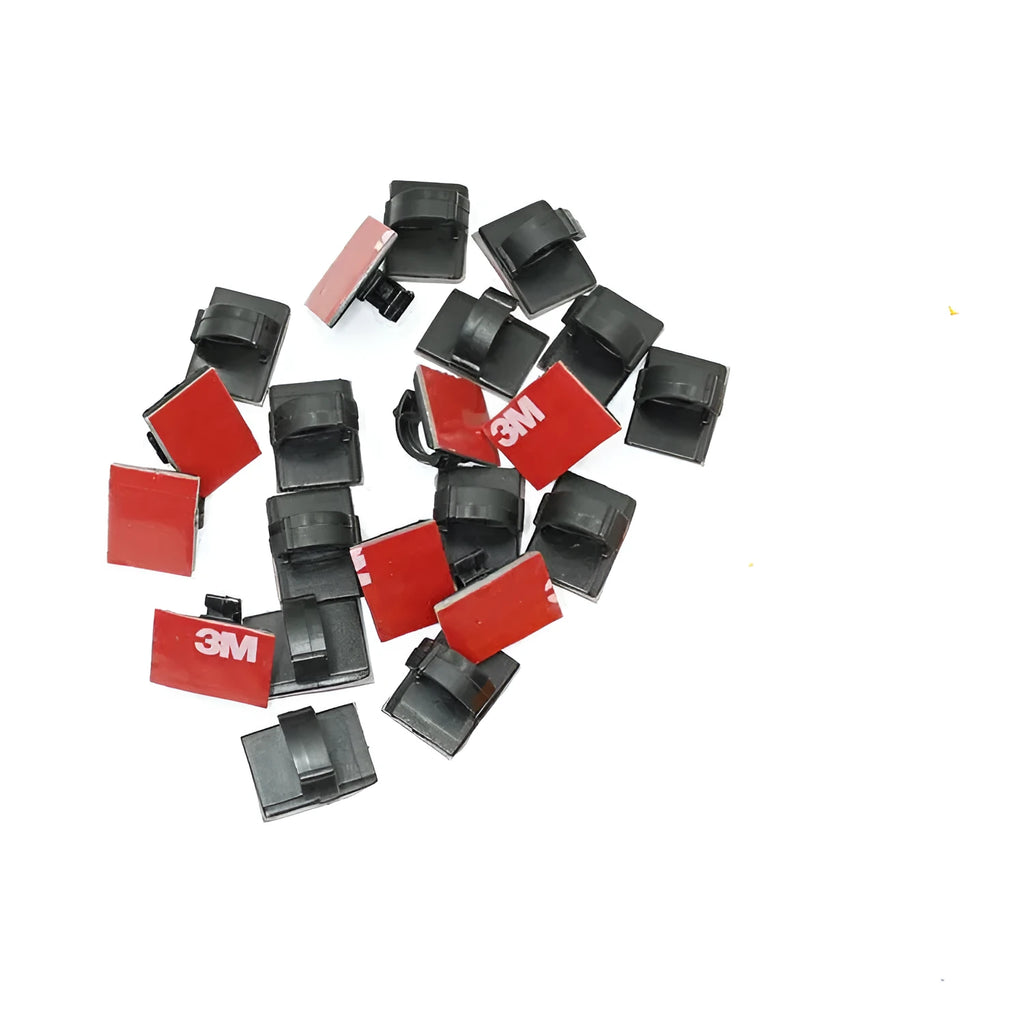 Black and white self-adhesive plastic flat cable clamps for wire organisation.
