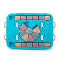 Blue plastic interactive dog puzzle feeder with sliding panel and four corner handles on a non-slip base