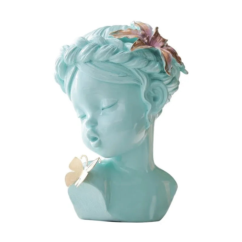 Nordic style resin character figurine in light blue and white on a desktop
