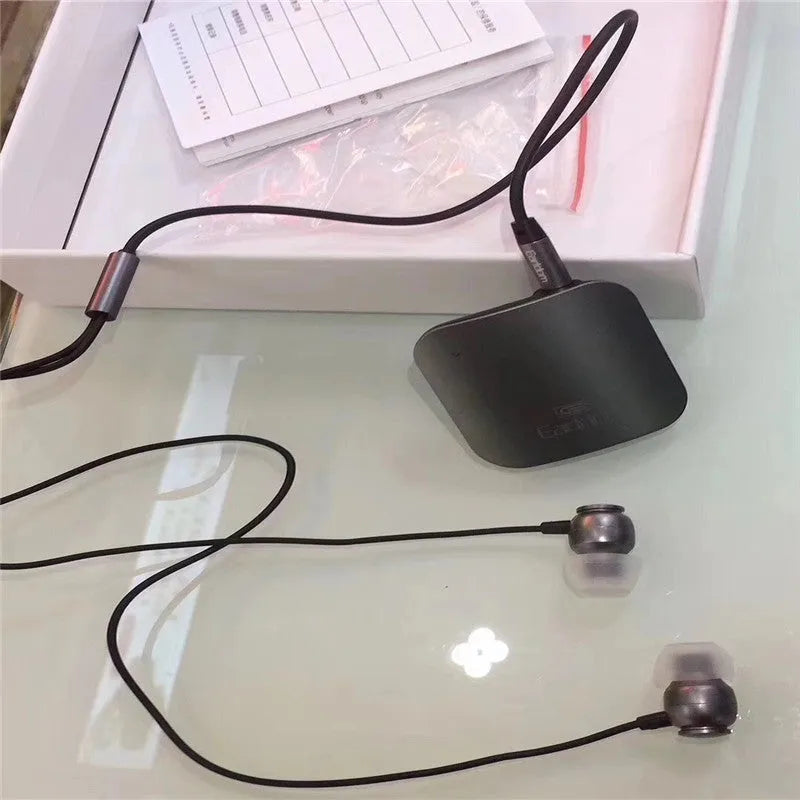 Black Bluetooth lavalier headset with earpiece and control unit, shown with packaging.