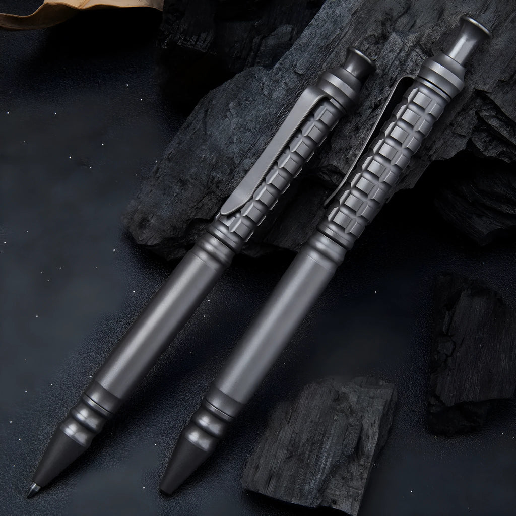 Gunmetal grey titanium alloy tactical pen with push-action button, shown in its gift box.